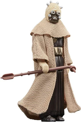 Figurine Star Wars The Book of Boba Fett – Tusken Warrior – Retro Collection – 9,5 cm – Hasbro. Guerrier Tusken avec tenue traditionnelle et gaderffii stick, au style vintage Kenner. Une figurine rétro parfaite pour les fans de Star Wars.