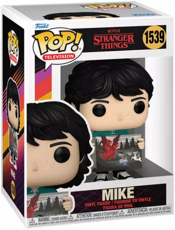 Funko Pop! Stranger Things â Mike (N°1539). Figurine de Mike tenant une illustration Dungeons & Dragons, fidĂšle Ă la sĂ©rie.