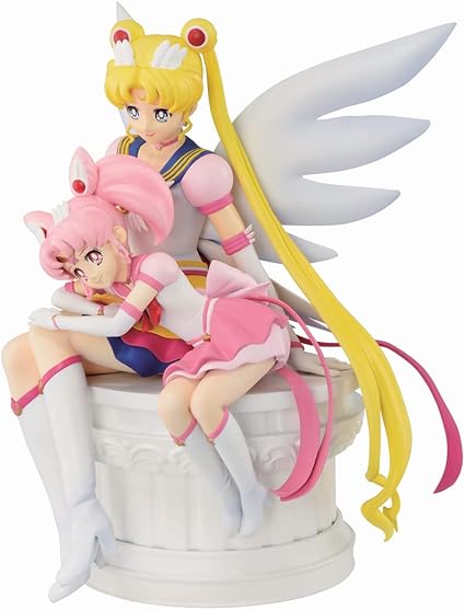 Figurine Sailor Moon Eternal Ichibansho (Bandai) représentant Eternal Sailor Moon assise sur un socle, tenant Eternal Sailor Chibi Moon contre elle, dans une scène pleine de tendresse et de magie. Hauteur 14 cm, détails soignés et couleurs éclatantes.