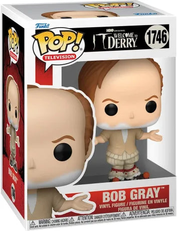 Funko Pop! Welcome to Derry – Bob Gray (N°1746). Figurine représentant la forme humaine de Pennywise avec tenue beige et pompons rouges. Une pièce glaçante pour les fans de Ça.