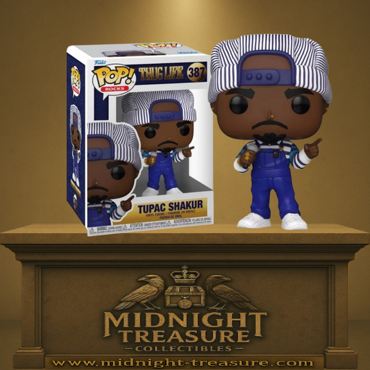 Funko Pop! Rocks – Tupac Shakur – N°387. Figurine de Tupac en salopette bleue et casquette rayée avec micro et bijoux. Une Pop! puissante et fidèle à l’icône du rap.