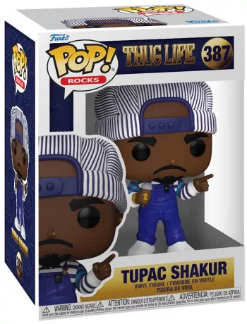 Funko Pop! Rocks – Tupac Shakur – N°387. Figurine de Tupac en salopette bleue et casquette rayée avec micro et bijoux. Une Pop! puissante et fidèle à l’icône du rap.