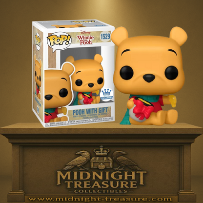 Funko Pop! Disney – Winnie l’Ourson (N°1529) – avec cadeau. Winnie assis avec pot de miel enrubanné, foulard vert et tenue hivernale. Une figurine douce et festive pour les fans de Disney.

