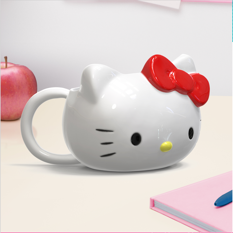 Mug Hello Kitty – Shaped – 300 ml – Officiel. Mug en céramique en forme de la tête de Hello Kitty avec son nœud rouge iconique. Un objet kawaii incontournable pour les fans de Sanrio et collectionneurs.