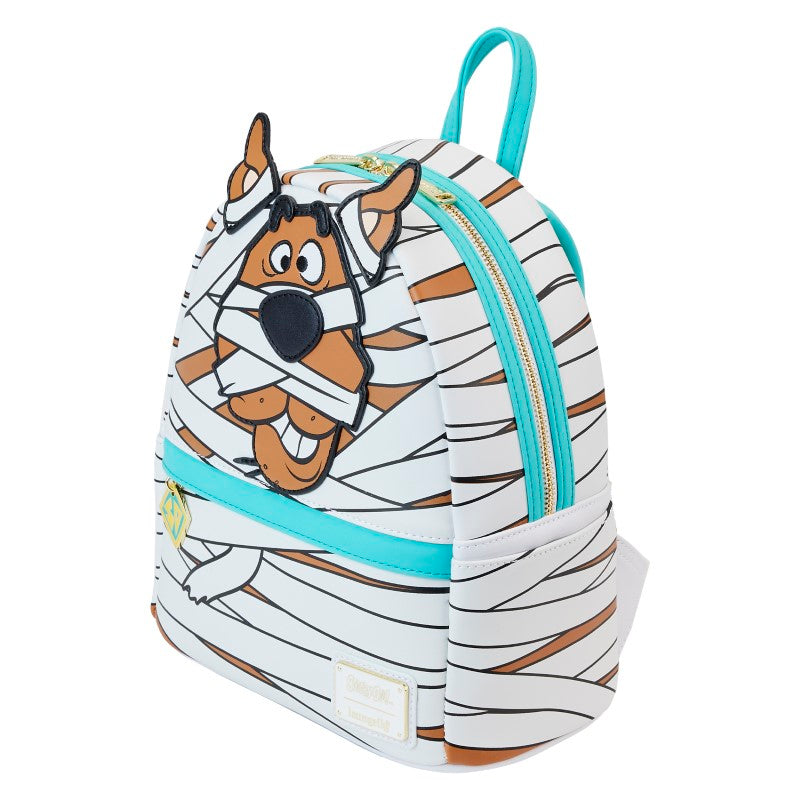 Sac à dos mini Loungefly – Scooby-Doo – Mummy Cosplay – 23 x 27 x 11 cm. Sac blanc et marron avec design de Scooby en momie, effet lumineux dans le noir et breloque logo Mystery Machine.

