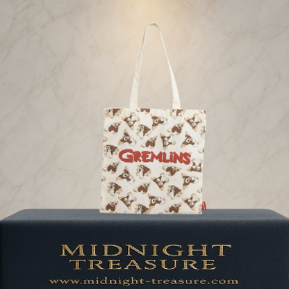 Tote bag Gremlins avec motif Gizmo répété et logo Gremlins rouge. Sac en polyester et coton de 36 x 39 cm, inspiré du film culte Gremlins, idéal pour un usage quotidien.